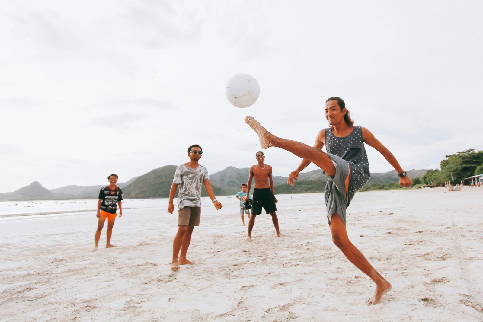 playing football at the beach